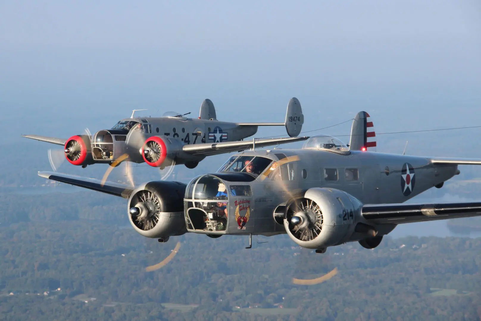 Two vintage World War II bombers flying in formation.