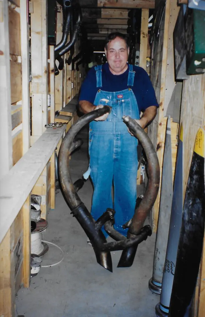 Person holding a large antler indoors.