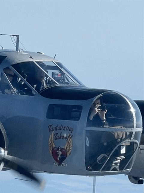 Close-up of a bomber aircraft nose with crew inside.