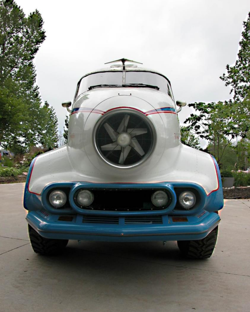 Front view of a retro-futuristic car with a jet engine design.