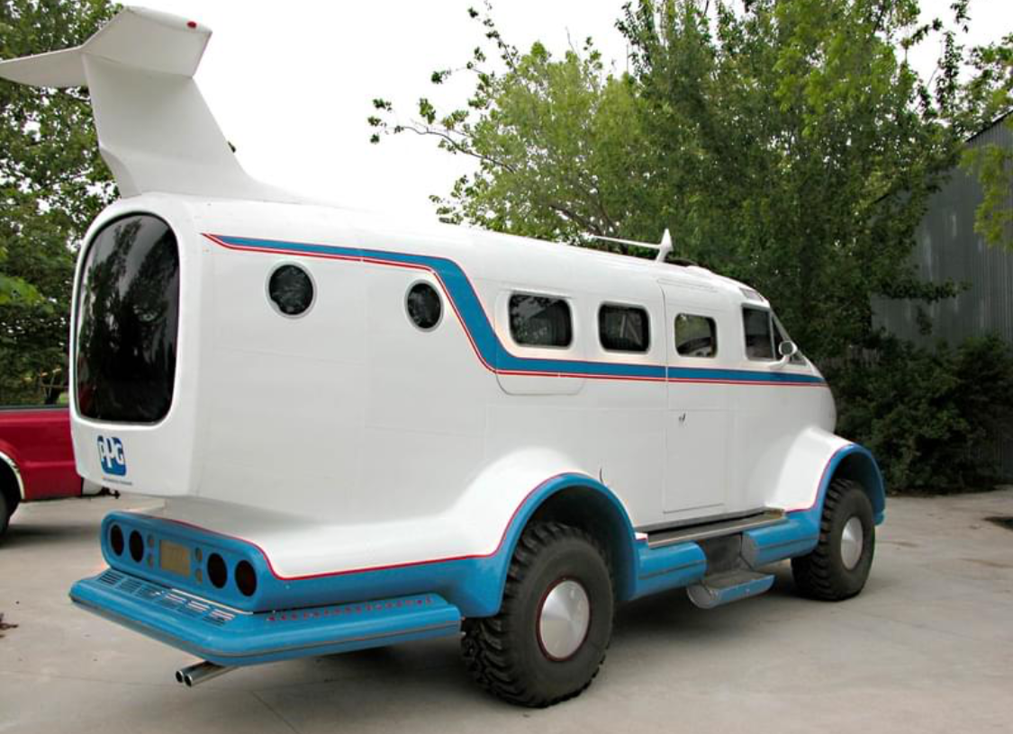 A unique retro-style vehicle with a white body and blue accents.